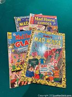 Four Archie Mad House comic books stacked with covers visible, showing colorful cartoon artwork.