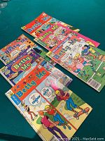 Six Betty and Me Archie comic books spread out showing colorful covers with various scenes