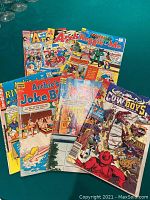 Photo showing seven Archie comic books including Archie Adventures, Archie Joke Book, Wild West Cowboys of Moo Mesa, and others.