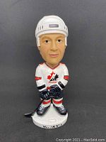 Front view of the Al MacInnis bobblehead in full hockey gear with Team Canada jersey and helmet.