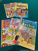 Photo showing 6 Archie comic books including 3 Jughead, 2 Betty and Veronica, and 1 Little Archie arranged flat with visible colorful illustrated covers.