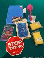 Overview of all items including notebook, spatulas, soap saver, pumice sponges, car magnet, and dental dam.