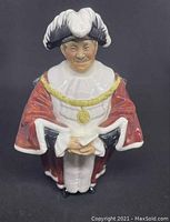 Front view of The Mayor figurine showing facial expression, robe, hat and scroll