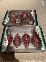 Set of 8 glass Christmas tree ornaments in original Holiday Frolic packaging. Top box shows 4 spherical glitter ornaments in multicolor checkered pattern.