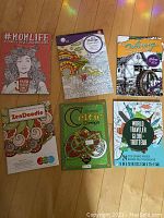 Lot overview showing all 4 adult colouring books with varied themes and covers.