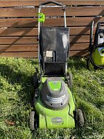 Front view of the Greenworks electric lawn mower showing grass catcher bag and handlebar