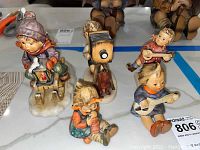 All five figurines arranged on countertop