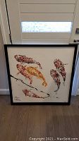 Full front view of framed koi fish painting against door