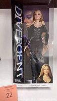 Full boxed view of the Divergent Tris Barbie doll with clear packaging showing outfit and box design.