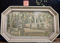 Front view of the framed tapestry showing Greek garden scene and Greek key pattern frame.