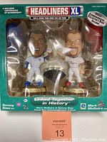 Front view of sealed box containing Mark McGwire and Sammy Sosa Headliners XL figurines with visible linked commemorative base and certificates of authenticity.