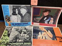Four vintage horror lobby cards displayed together on a flat surface.