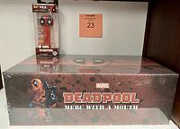 Photo showing large sealed Deadpool Merc With A Mouth box and limited edition Deadpool PEZ dispenser in retail packaging