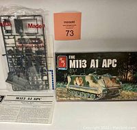 Photo showing the original sealed plastic sprues, decal sheet, instruction manual, and box of the FMC M113 A1 APC model kit.