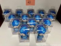 Lot of 14 boxed and sealed Mega Man Bobble Budds figures arranged in rows, clear plastic packaging showing the figures inside.