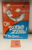 Front cover of the 1955 Dr. Seuss book "On Beyond Zebra" showing colorful illustration with a whimsical creature and the title.