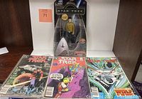 Lot displayed showing three Star Trek comic books from 1986 laid out side-by-side on shelf.