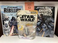 Front view of the Star Wars Rebellion graphic novel, Knights of the Old Republic graphic novel, and the Mace Windu action figure in original packaging, showing lot contents.