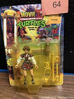 Front view of April O'Neal figure in plastic blister pack on original Teenage Mutant Ninja Turtles Movie III themed card showing figure and accessories