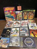 Photo showing multiple video games and a Nintendo Power magazine with Star Tropics cover.