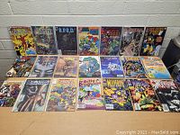 Photo showing a large set of 18 assorted comic books laid out flat, featuring superhero and fantasy titles like Fantastic Four, Mystic, B.P.R.D., Dragon, Wolverine, and Avengers.