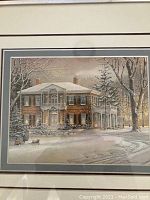 Full view of the framed print showing a winter scene with a large house and snow-covered trees.
