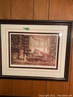 Framed print showing overall with wood panel wall background.