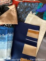 Close-up view of multiple colorful scarves with floral and geometric patterns
