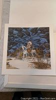 Close-up photo of the limited edition print 'Eagle Heart' showing Native American figure on a white horse standing in a snowy, rocky landscape with detailed shadows and winter vegetation.