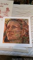 Photo of the limited edition print showing the detailed artwork of a woman's face merged with nature, with the certificate or print information visible in the background.