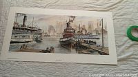 Wide view of the limited edition signed print depicting harbor scene with boats and city skyline, laid flat on a white surface.