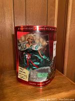 Full view of the 1995 Happy Holidays Barbie doll in original red display box with holiday greetings, showing box wear