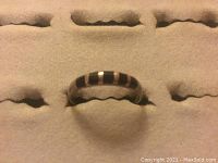 Front view of the sterling silver ring showing the alternating onyx stone inlay pattern.