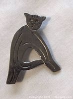 Front view of the sterling silver cat brooch showing stylized design and engraved face details.