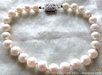 Full view of creamy white cultured pearl bracelet, approximately 7.5 inches long, showing size and color of pearls and clasp positioning.