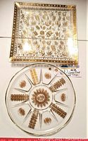 11.25-inch round divided glass tray with gold floral motifs in each compartment, central sunburst flower design, no visible cracks or chips