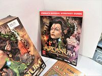 Original Arcanum game box with cover art, and Prima Official Strategy Guide shown upright next to it