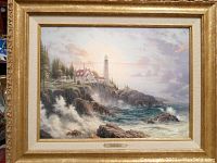 Full view of framed lithograph showing coastal scene and frame style