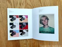 Open book showing a page spread with multiple color variants of a skull artwork on left and a photograph portrait of Andy Warhol on right.