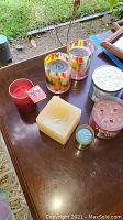 Overview of the box containing various candles of different styles and colors