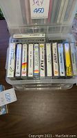 Clear plastic case with multiple audio cassette tapes visible. Titles include jazz and classical music.