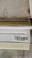 Close-up of barcode label and part of the air conditioner unit with dirt marks.