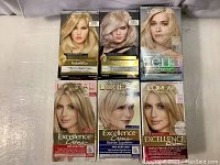 Front view of six L'Oréal hair dye boxes arranged in two rows showing models with blonde hair and product names.