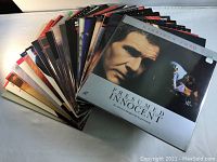 Laserdiscs arranged in a fanned out stack, cover of "Presumed Innocent" featured prominently.