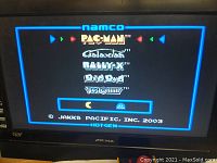 TV screen showing Namco game list including Pac-Man, Galaxian, Rally X, Dig Dug, Boscoman.