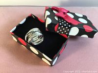 Silver rhodium plated Swarovski ring with clear Austrian crystals, displayed in a black, white and red polka dot gift box with a red ribbon.