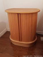 Front view of bedside table with tambour doors closed