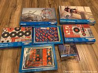 Photo showing all 7 boxes included in the lot - two main kits Statik and Motor + Getriebe, four add-ons, plus Woodburning Art stencil/instructions box.