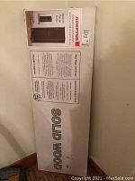 Photo of the box showing product details including brand, product type, dimensions, and finish color.