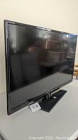 Side view of the 40 inch older Fluid flat screen TV on its stand